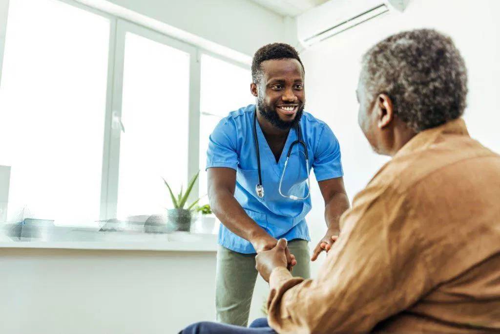 a-nurse-caring-for-an-old-man Canada caregiver program 2026