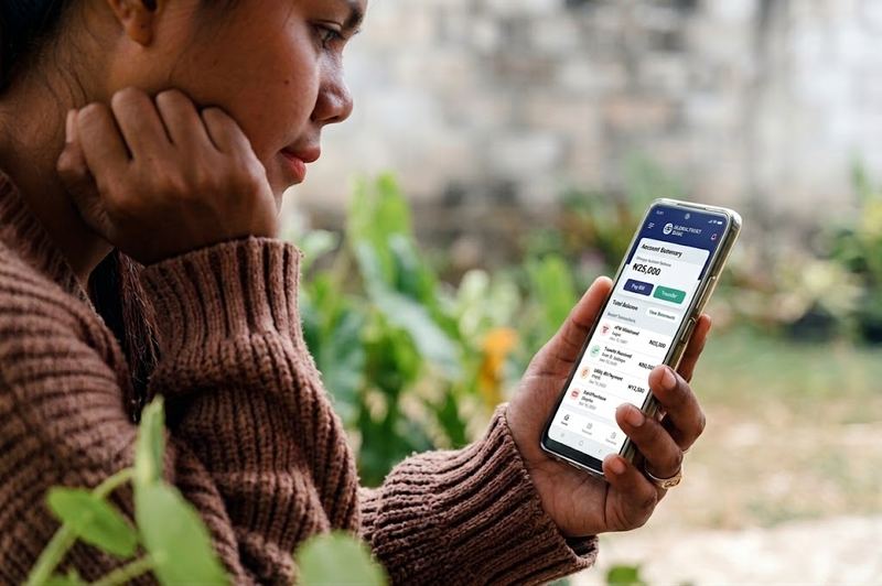 lady checking her phone guide to loan app calling my contacts Nigeria